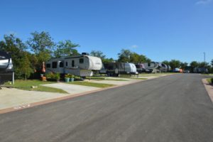 RV's parked in spacious concrete lots at Hardy's Resort RV Park in College Station, Texas.