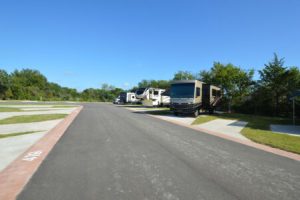 RV's parked in spacious concrete lots at Hardy's Resort RV Park in College Station, Texas.