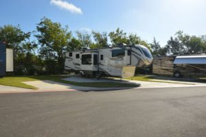 RV's parked in spacious concrete lots at Hardy's Resort RV Park in College Station, Texas.